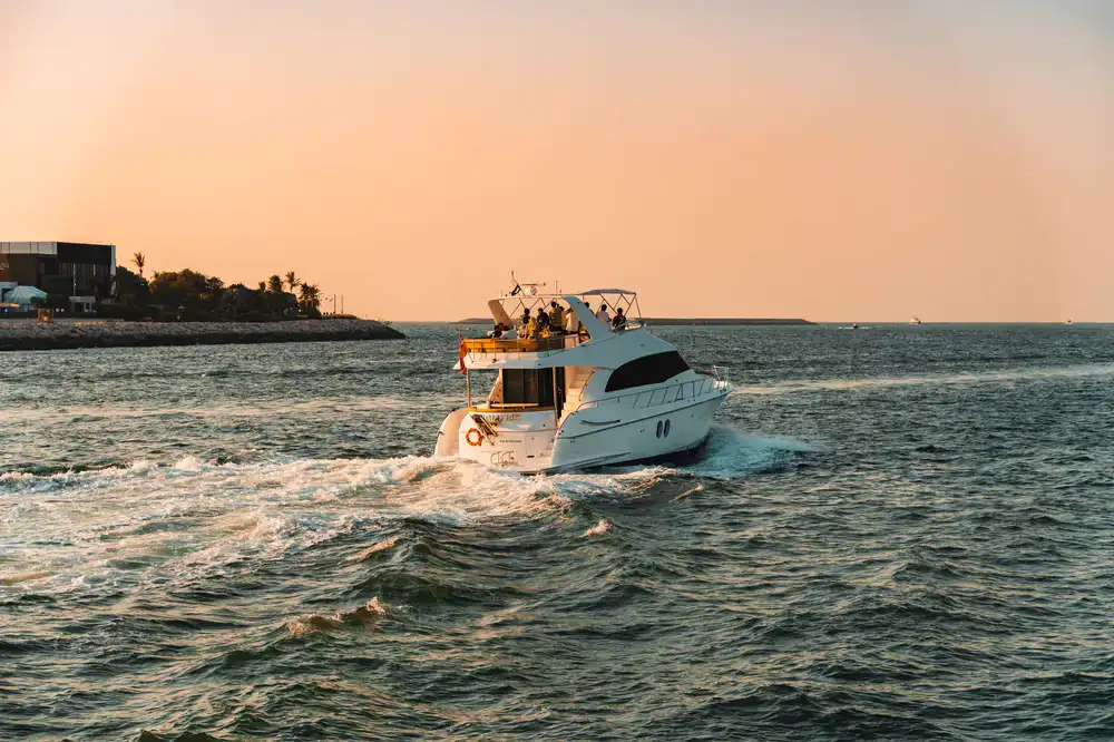 Charter boat cruising along a sweeping coastline