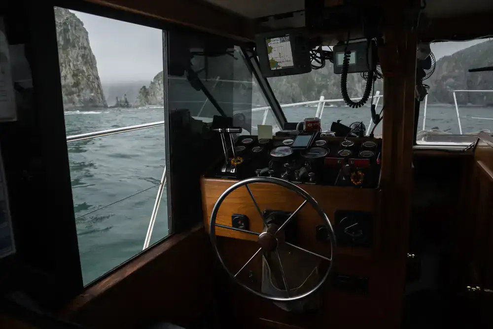 View of the coastal cliffs from the deck of the boat