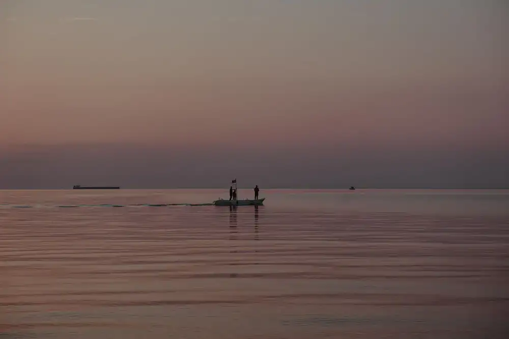 Calm sea waters reflecting the evening twilight colors